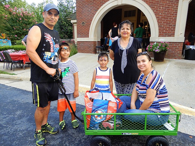 Having fun at Sully Station are (from left) Alex Calancha, sons Christopher, 6, and Anthony, 4, Calancha’s mother Lourdes and his wife Veronica.