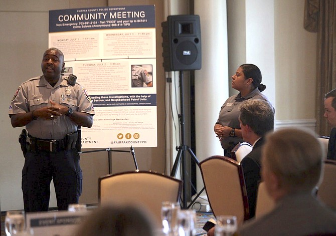 Officer Marvin Goodley of Mount Vernon Police Station (left) discusses the safety programs the station offers for business owners.