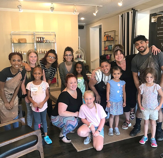 Students from Cornerstones Laurel Learning Center in Reston (back row, second from left) Alessandra Twohie Crowe, grade 6; (middle row) Maha El-Buruju, grade 1; Jannah Mohamed, grade 1;  (front row) Lauren Eaglet, grade 3; Alex Lucier, grade 1 and Hannah Todd, grade 1, show off their new school year haircuts provided courtesy of stylists at Maude, a boutique salon in the Town of Herndon.