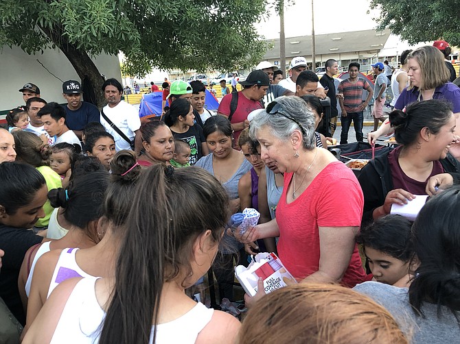 Jordana Carmel of Kindworks handing out supplies at a tent city right over the bridge from Texas in Mexico. The group collected supplies in Montgomery County and drove a truckload to the border to distribute them to those in need.