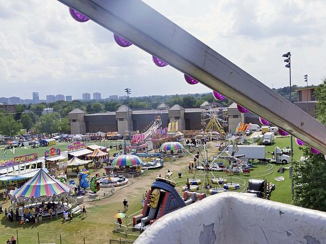 The fairground is spread out below before the riders at the top of the Ferris wheel on Friday, Aug. 16 at the Arlington County Fair.