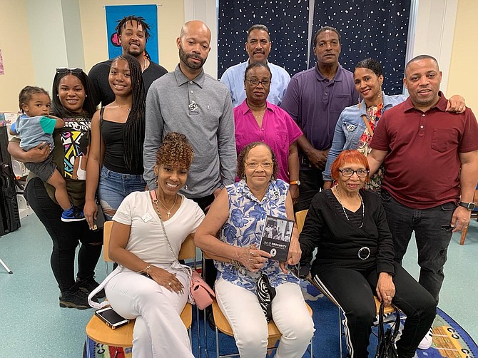 Four generations of the William “Buddy” Evans family gather at the Barrett Branch Library on Aug. 19 to commemorate the 80th anniversary of the 1939 Alexandria Library Sit-In. Seated in front are Evans’ daughters Joyce Angela Evans Jackson, center, and Beverly Wanzer, right, surrounded by children, grandchildren, great-grandchildren and a great-great grandchild.