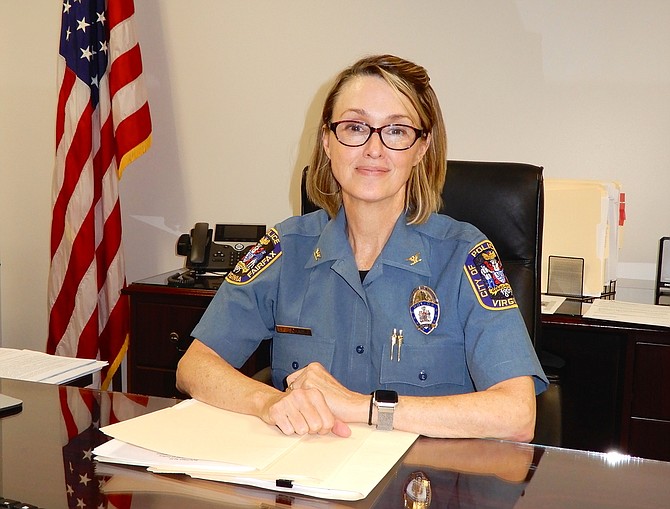 Police Chief Erin Schaible at her desk in Fairfax City’s police station.