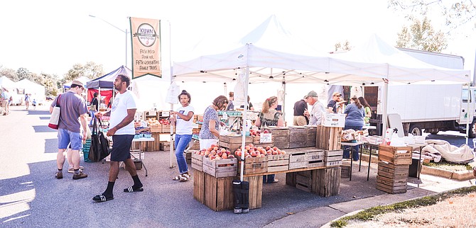 Crowded with customers regular and new, the three produce stands that appear at the Lorton Farmers Market are filled with conversation and fresh produce. “It is a smaller market so you get to know all of the vendors. We always interact with them.” says customer Curtis White.