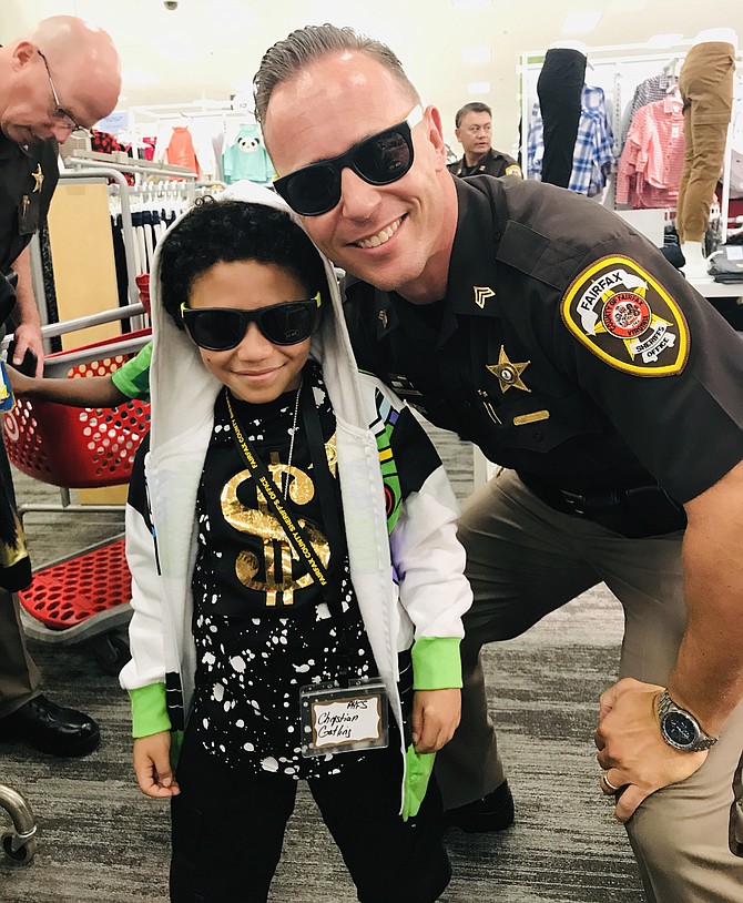 Two cool dudes, Sergeant C. M. Loftis, Public Information Officer for Fairfax County Sheriff’s Office, and Christian Gatling don their shades as they go back-to-school shopping together at Target in Burke during the 2019 Shop with the Sheriff Program.