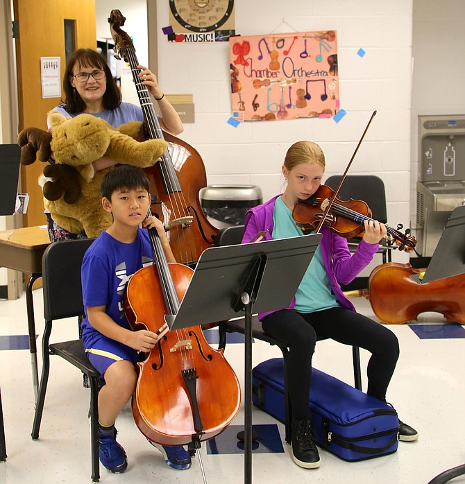 Ruth Donahue, music teacher, with her students, violinist Jolie Korfonta and cellist Daniel Kim.