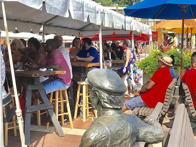 During the 13th Annual Lake Anne Jazz & Blues Festival, the bronze statue of Reston founder Robert E. Simon sitting on the lakeside bench.