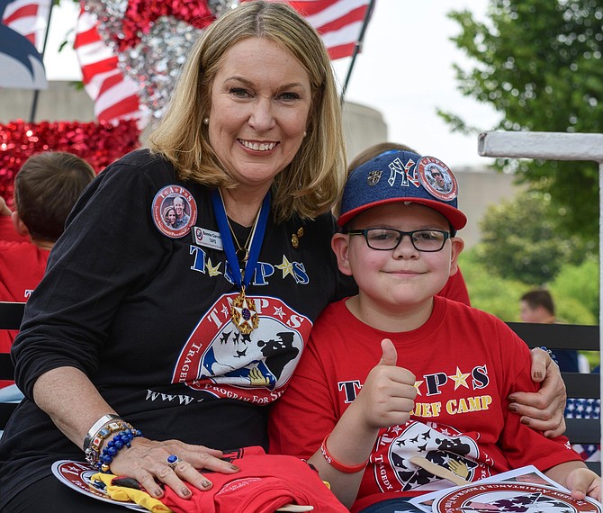 Bonnie Carroll, founder of TAPS, Tragedy Assistance Program for Survivors, with a participant in one of TAPS’ Good Grief camps.