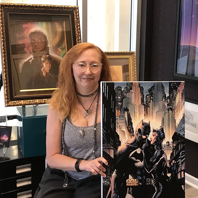 After creating and moderating her eight-person panel, Women Rocking Hollywood 2019: Women-powered Projects and the Push Towards Parity for the 2019 Comic-Con International in San Diego (Comic-Con), Leslie Combemale enjoys a moment at the gallery she co-owns and operates, ArtInsights Gallery of Film and Contemporary Art in Reston Town Center.