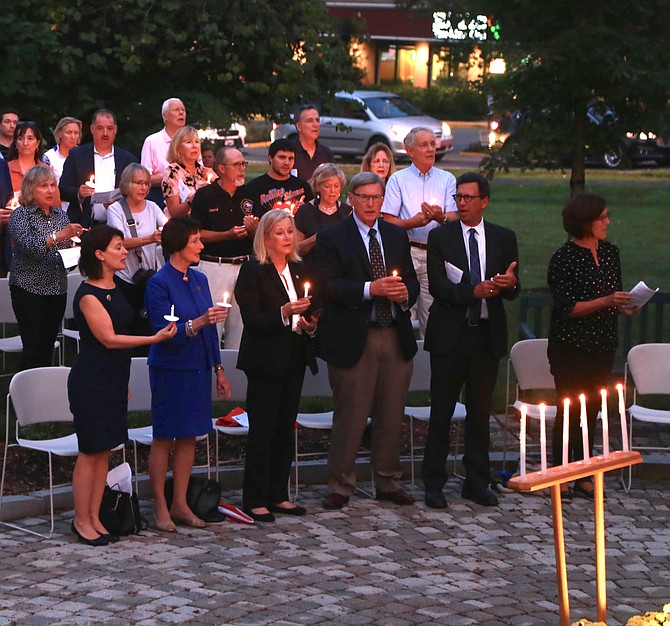 From left: State Sen. Barbara Favola; Chairman of the Fairfax County Board of Supervisors Sharon Bulova; Del. Kathleen Murphy; Dranesville District Supervisor John Foust; and former Great Falls resident and CNN Washington Bureau Chief Frank Sesno lit the candles to honor the lives that were lost on 9/11.