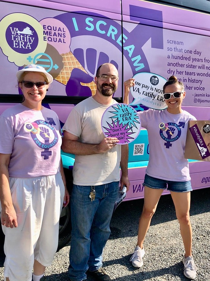 Advocates Jane Materna and Johanna Guzman offer voter Calvin Hentges ice cream and ERA information.