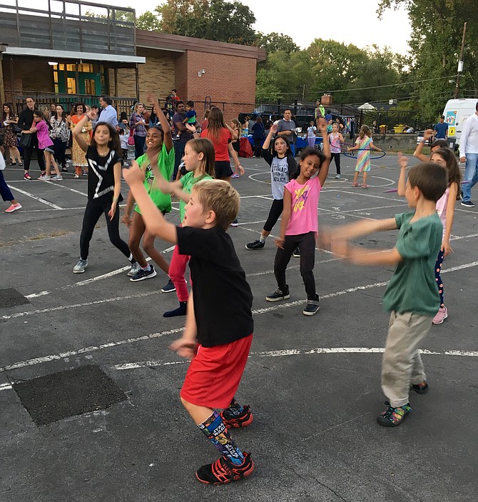 Students dance to music by Deejays Freddy, Chris and Bam Bam of Glide Productions at the Potomac Elementary Back to School Picnic Friday.