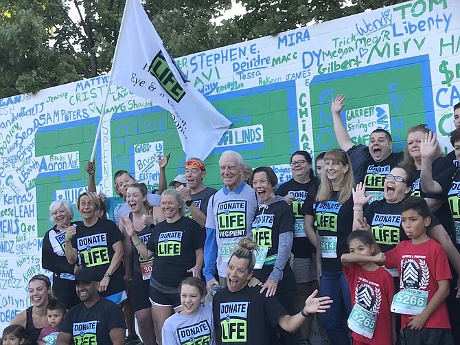 Runners and walkers gather before the start of the 12th annual Susco 8K: Running with Tim to promote brain aneurysm research and organ donation awareness.