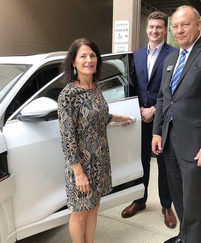 Donald Davidson, Manager of Government Relations, Volkswagen Group of America (second from right), shows off the Audi-E-Tron with the first pure battery long-range car electromobility during the panel presentation, "In a Word – Transportation!” hosted by the Dulles Regional Chamber of Commerce.