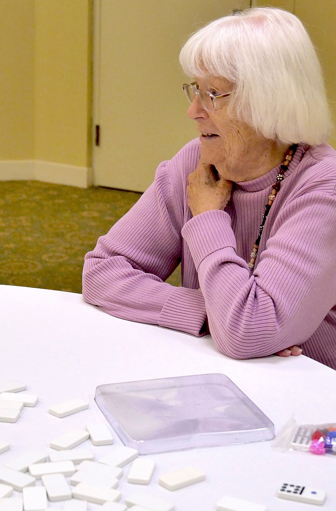 Ninety-six-year-old Eva Sorensen from Alexandria is the oldest competitor in Mexican train dominoes in this year's Northern Virginia Senior Olympics, held at Goodwin House.