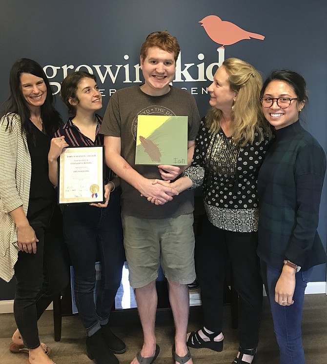 At Growing Kids Therapy Center in Herndon, Meghann Parkinson, Educator, holds the Certificate of Congratulations presented to Ian Nordling by Town of Herndon Town Council in recognition of his hard work and excellence as Member of the Herndon Youth Advisory Council 2017-2019. Also pictured, from left: Kelly Berg, Educator, Elizabeth Vosseller, Director and Janine Abalos, Educator.