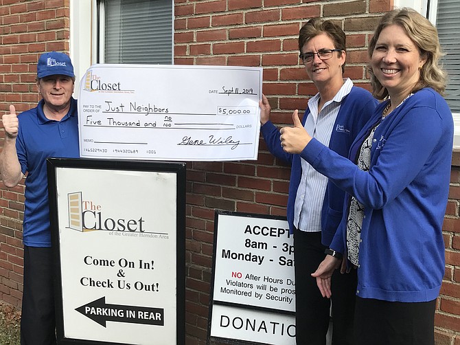 Erin McKenney, Executive Director of Just Neighbors, and Stephanie Barnes, Operations Director, accept a $5,000 grant award on behalf of the organization from Gene Wiley, President of The Closet of the Greater Herndon Area, Inc.