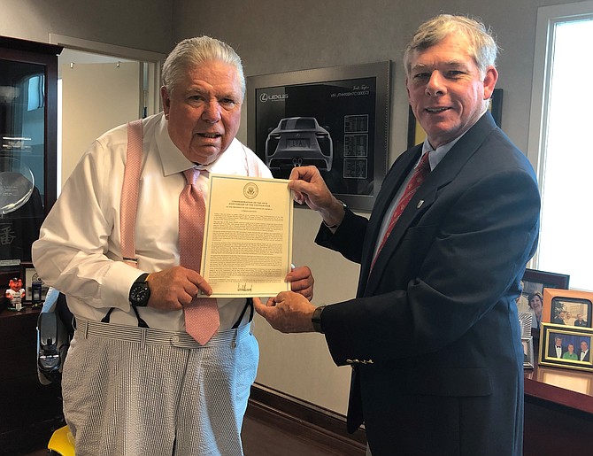 Jack Taylor, left, is presented with the Department of Defense 50-year Commemoration of the Vietnam War certificate by Kevin Rue of the Friends of Rocky Versace organization Sept. 17 at Jack Taylor’s Alexandria Toyota dealership. Taylor is a Vietnam veteran and served in the Army’s Military Police in Saigon in 1971.