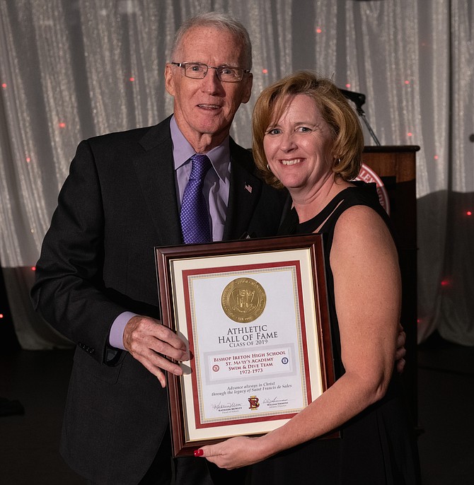 Harry Sober, left, coach of the combined BI/St. Mary’s Academy 1972-73 Swim and Dive team, accepts the Bishop Ireton Athletic Hall of Fame certificate from Head of School Kathleen McNutt.