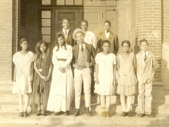 A 1927 Parker-Gray School play; Joseph C. Waddy is standing in the front row with the hat on his head.