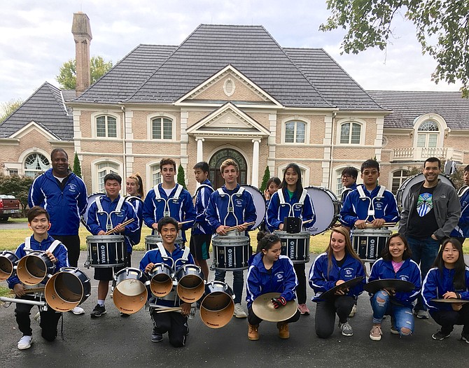 Members of the Winston Churchill High School Drumline wait for the Potomac Day parade to begin.