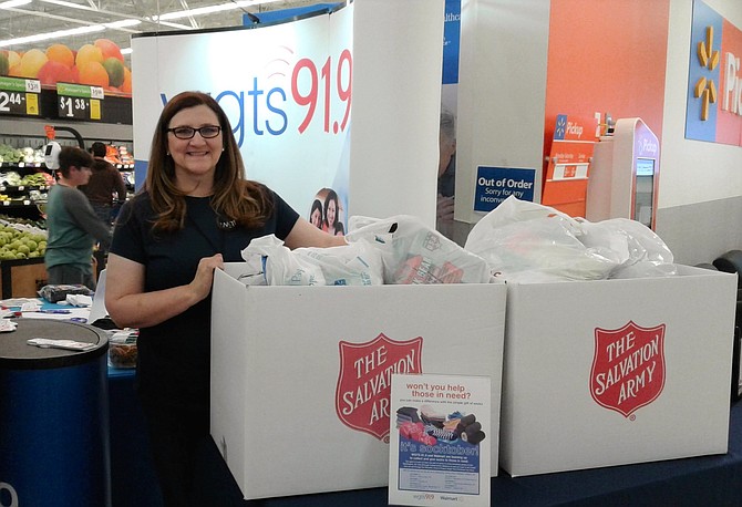 Centreville resident Tina Atwell is a first-time volunteer for Washington-area radio station WGTS 91.9 at its “Socktober” collection drive Oct. 11 at the Chantilly Walmart, where she accepted donations of socks for two local charities ― the Central Union Mission of D.C. and the Salvation Army ― that serve homeless individuals and families.
