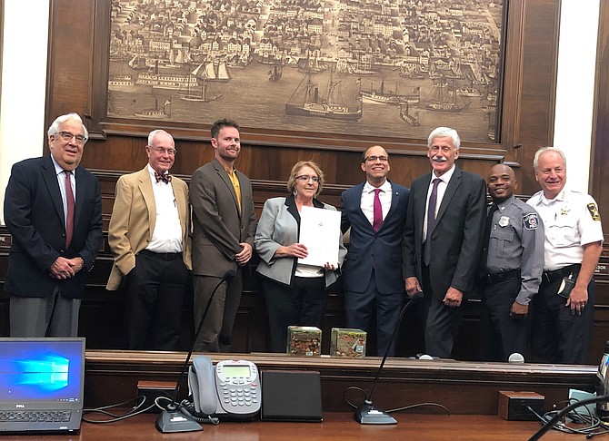 Alexandria Public Defender Melinda Douglas, center, is surrounded by city officials and dignitaries during a proclamation ceremony honoring her service Oct. 2 at City Hall.