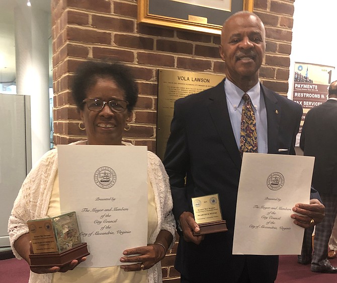 Frances Terrell, a member of the Fort Ward Interpretive Committee, and McArthur Myers, hold the Ben Brenman awards following a presentation by City Council and the Alexandria Archeological Commission Oct. 2 at City Hall.