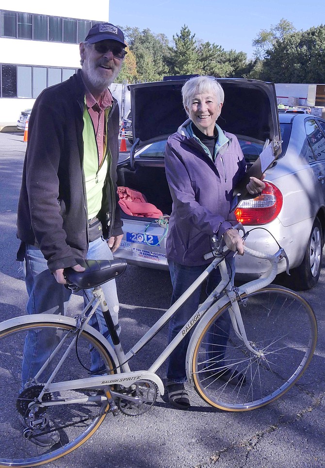 Keith Oberg, who originated Bikes for the World in Arlington in 2005, accepts an old Raleigh bike from Sharon Simkin. She said the bike had been converted from a three-speed to a five-speed.