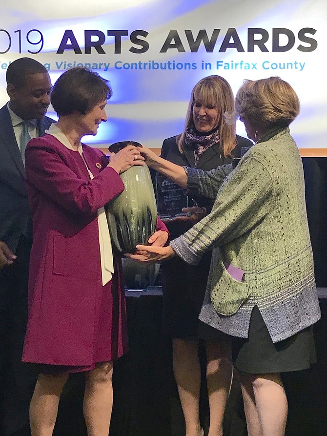 Sharon Bulova, Chairman of the Fairfax County Board of Supervisors, accepts both her crystal award and ceramic vessel created by artist Bikki Stricker of Falls Church, from Linda S. Sullivan, President and CEO ARTSFairfax, in recognition as the 2019 Honoree for the Jinx Hazel Arts Award.