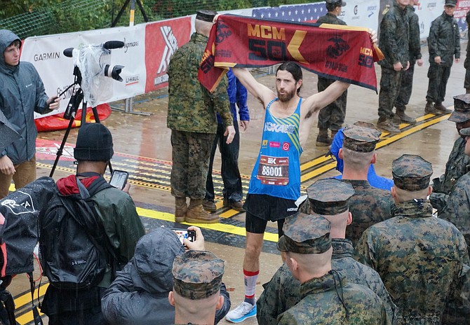 Arlington’s Michael Wardian celebrates winning the inaugural Marine Corps Marathon 50K race Oct. 27 in Arlington. A world-renowned ultra distance runner, Wardian, 45, completed the course in 3:11:52.