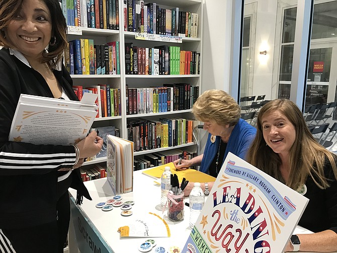 Janet and Theresa Howell sign copies of their new book with forward by Hillary Rodham Clinton.