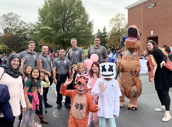 The Fairfax County Police Department interacts with kids dressed up in creative costumes at the fall festival.