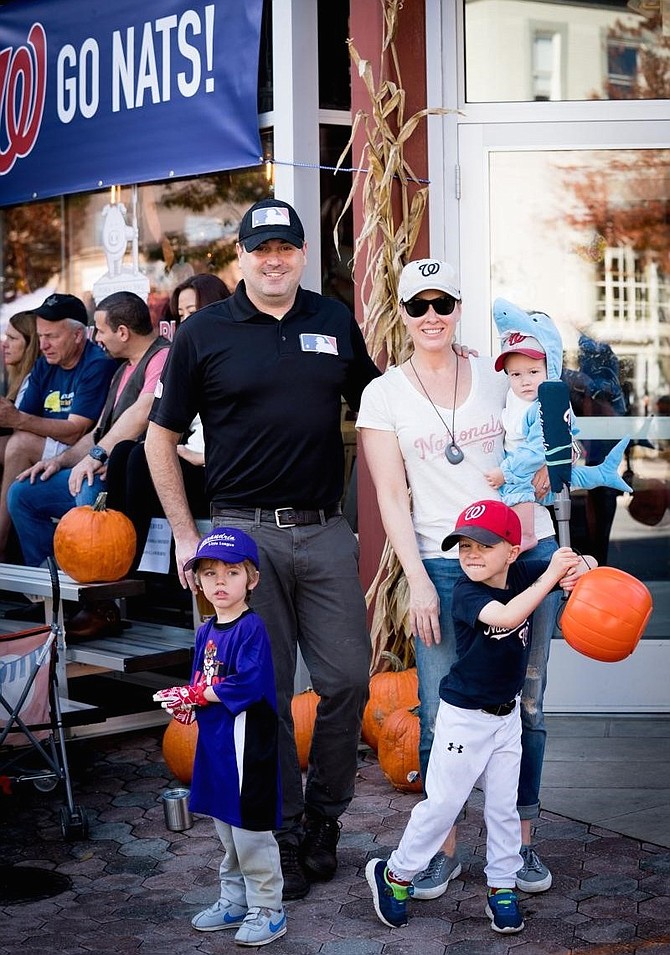 Bill Blackburn, owner of Pork Barrel BBQ and past president of the Del Ray Business Association, enjoys the 23rd annual Del Ray Halloween Parade with his wife Megan, their sons and a friend Oct. 27 in Del Ray.