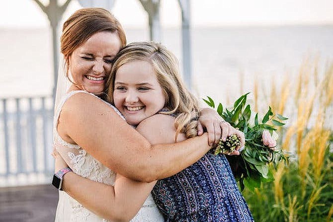 Sarah Aiken and Kinley Strohl meet for the first time at Aiken's wedding.