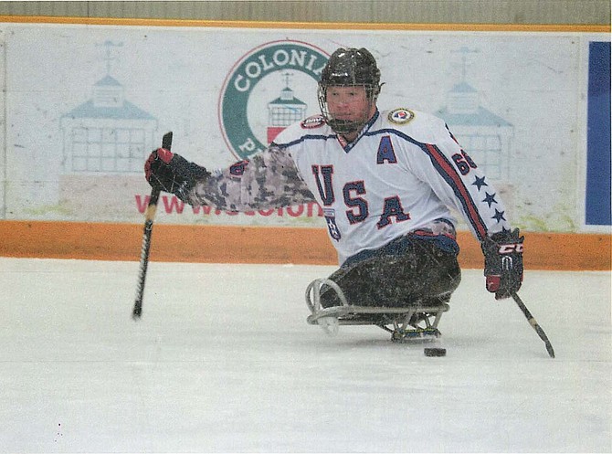 Rob Easley playing sled hockey with the USA Warriors sled hockey team.