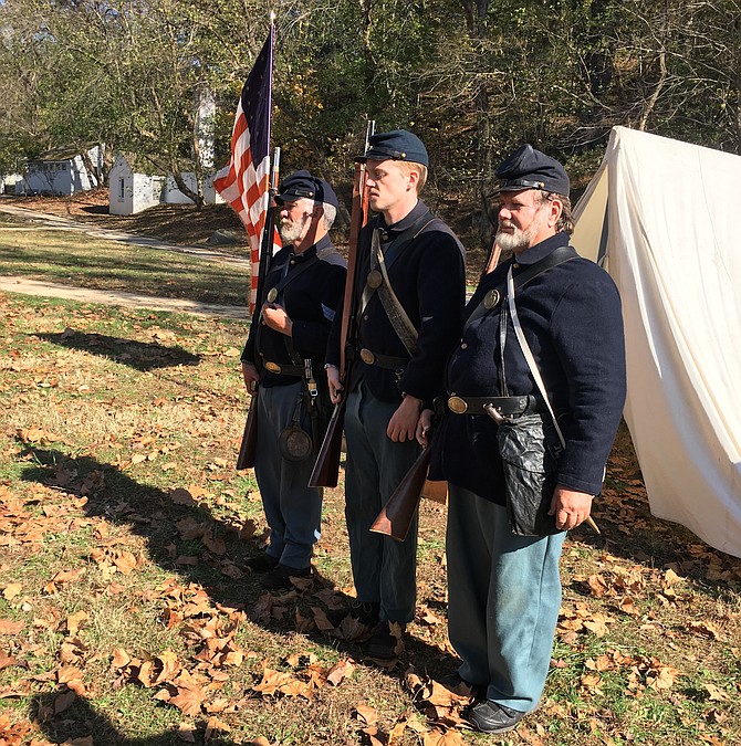 Tom Youhn, left, explains the role of the 20th Maine Regiment along the C&O Canal during the Civil War. He explained the importance of keeping the waterway in the hands of the  northern states as it was used to carry supplies to armies stationed along the canal from Washington City to Cumberland, Maryland. Civil War reenactors from the 20th Maine Regiment held a Civil War Encampment at Great Falls Tavern Visitors Center on Nov. 2 and 3.