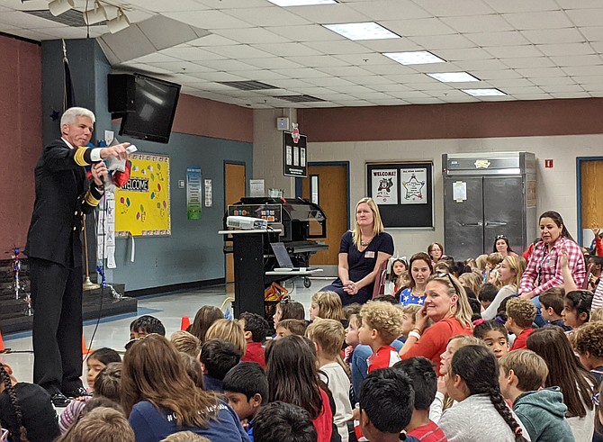 Rear Admiral Karl Thomas, brother of Aldrin fourth grade teacher Natalie Ward, addresses the student body.