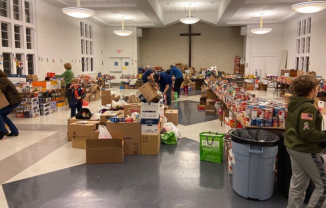 Cub Scouts and volunteers sort donated food following their participation in 'Scouting for Food in the Fight Against Hunger.'