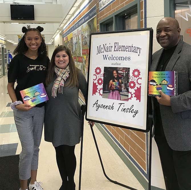 From left: Author/illustrator and Westfield High School student Ayonnah Tinsley celebrates with Fairfax County Public School principals Melissa Goddin, McNair Farm E.S and Dr. Anthony E. Copeland, Westfield, following the reading and discussion for her children's book, 'This is What an Engineer Looks Like' (2019) to students at McNair Farm Elementary School in Herndon.