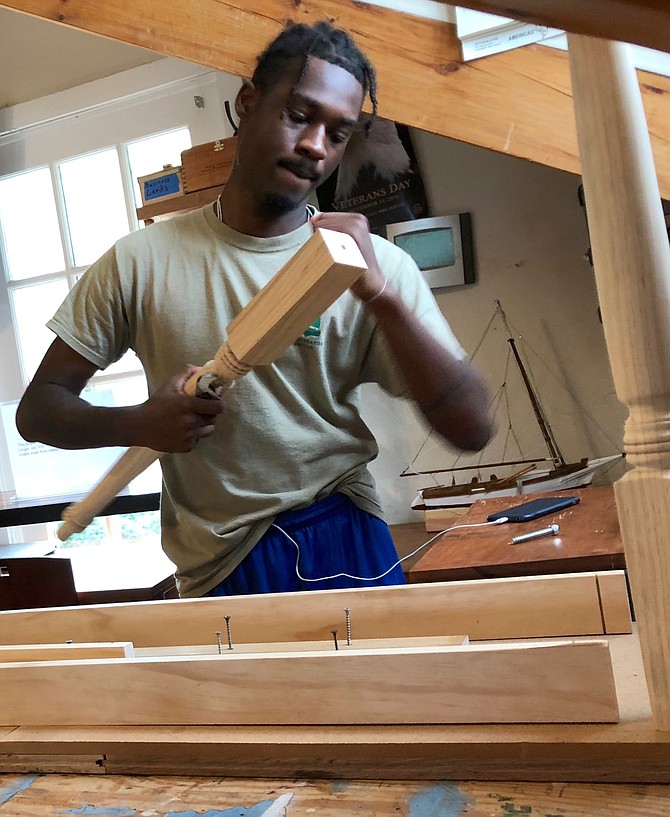 Alexandria Seaport Foundation apprentice Brian works on a table at the ASF workshop on the Old Town waterfront.