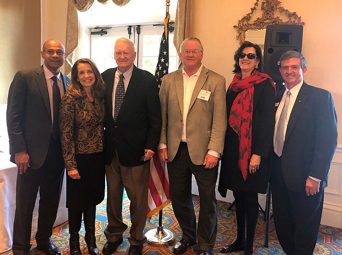 Capt. Eugene “Red” McDaniel, third from left, following his keynote address at the Chamber of Commerce Salute to Veterans Nov. 6 at Belle Haven Country Club. With McDaniel are: RADM Vince Griffith (ret);  event chair and National Industries of the Blind executive vice president Angela Hartley; Michael McDaniel; Chamber board president Charlotte Hall; and Jim Lindsay of ACCfamily, an organization founded by McDaniel to provide homecare for seniors in Alexandria.