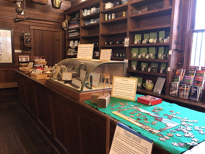 The original general store counter, topped with toys and mill-building tools.