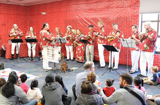 The Northern Virginia Ukulele Society performs classic Sesame Street songs like "Sunny Day" and "I Love Trash" during a performance at the Reston Regional Library.