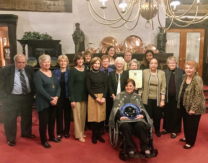 Potomac Chamber of Commerce 2019 CITIZENS OF THE YEAR: Friends of the Library-Potomac Chapter board members and supporters. From left, Neil Currie, Geraldine Bernard, Margaret Vogel, Jacqueline Etelson, Denise Pierson, Karin Currie (FOL-Potomac vice president and founder), Judy Davis, Lysette House (Friends of the Library-Montgomery County), Edythe Wingate (FOL-Potomac board president), Carol Westrick (seated, holding inscribed plate), Ralph Buglass, Ginny Barnes (nominator, holding Maryland Proclamation), Adrienne Miles Holderbaum (Potomac Library Manager), Sheila Graves, Selby McPhee, Doris Valis.