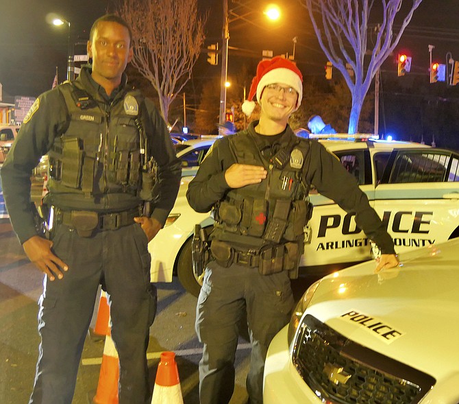 Corporal J. Green and Officer Glenn Foust join a team of seven Arlington County Police officers manning their police cruisers Thursday night at the Harris Teeter parking lot.