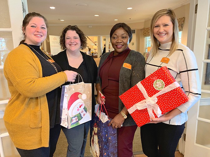 Gathering gifts for a visit from Santa’s motorcade to Sunrise of Arlington are Amanda Sylvester Williams, Lisa Johns, Bora Bisimwa and Lauren Webster. The toy drive motorcade will arrive Dec. 7 between 9-10 a.m. and will benefit Easter Seals children.