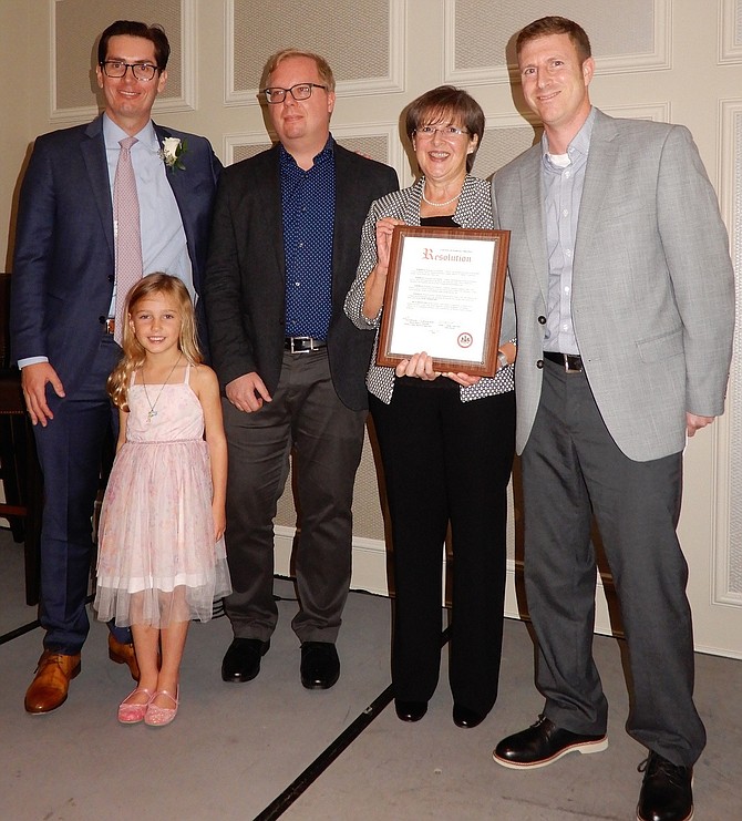 From left are Andrew Casteel and daughter Elizabeth, 6; Chris Holland; Kathy Smith and Brien MacKendrick. The Chantilly Wegmans received WFCM’s Community Service Award.