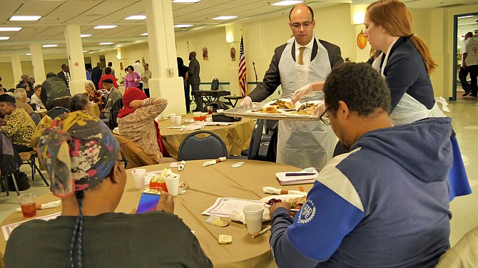 Mayor Justin Wilson and Vice Mayor Elizabeth Bennett-Parker serve Thanksgiving dinner to Alexandrians attending the community Thanksgiving event Saturday, Nov. 16.