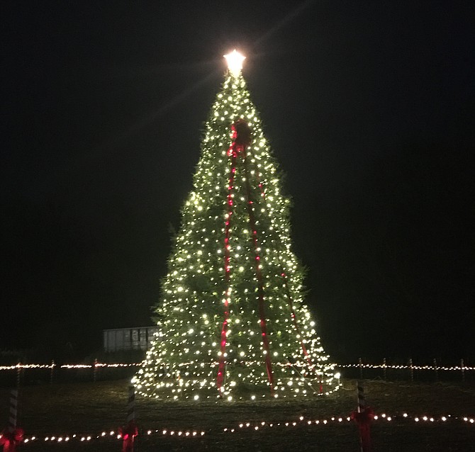 Although other activities were cancelled due to anticipated rain,  the newly planted tree was lit by Steve Borcherding, Bob Moore, Debbie Moore Chason and Mike Kearney on Sunday, Dec 1.